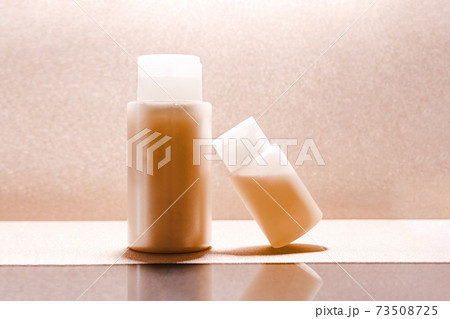 Transparent cosmetic beauty bottles on golden minimalist 73508725
