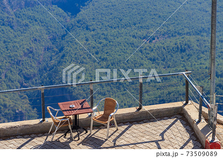 Table and chairs on a viewing platform for rest on a top of Tahtali mountain near Kemer, Antalya province in Turkey 73509089