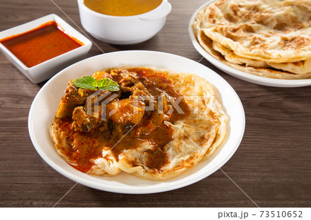 Roti Parata or Roti canai with lamb curry sauce. Roti Parata or Roti canai with lamb curry sauce. 73510652