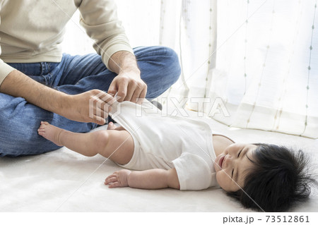 赤ちゃんの紙おむつ交換する父親(0歳、生後6ヶ月、女の子、日本人) 73512861
