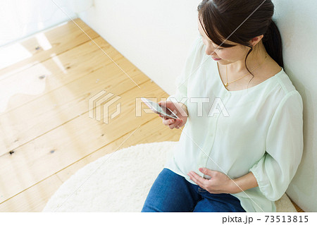 スマホを見る女性　マタニティ 73513815