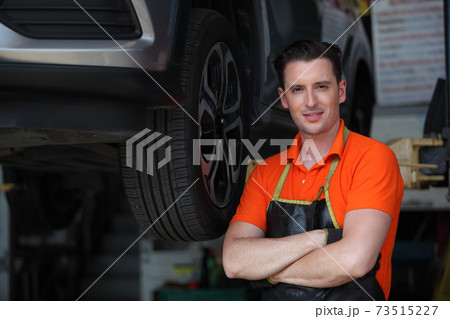 Portrait of a mechanic at work in his garage or car repair service or auto store, business, maintenance and people concept Portrait of a mechanic at work in his garage or car repair service or auto store, business, maintenance and people concept 73515227