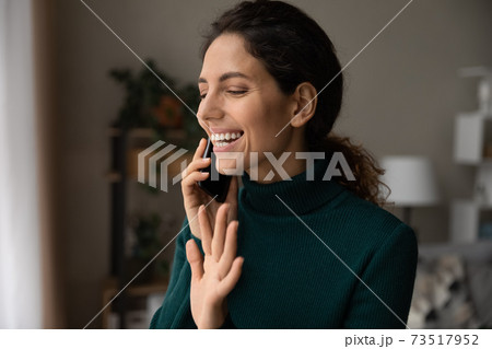 Smiling woman look in window talking on cellphone call 73517952