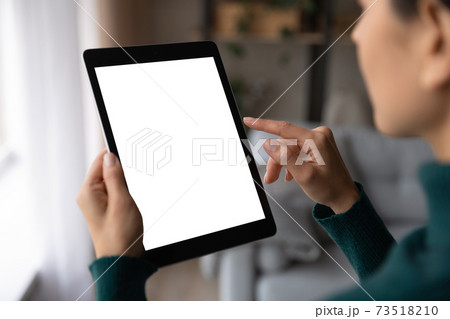 Close up woman use tablet texting online Close up woman use tablet texting online 73518210