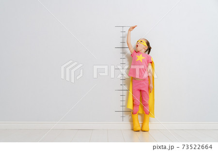 child is playing superhero child is playing superhero 73522664