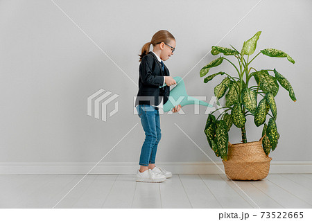 Kid is watering plant 73522665