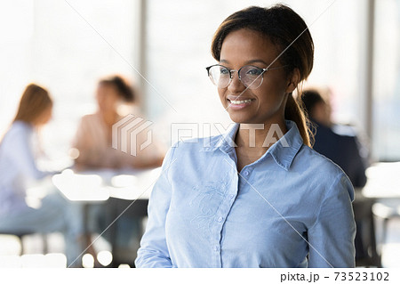 Smiling African American woman worker look in distance thinking 73523102