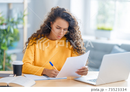 woman working on laptop at home. woman working on laptop at home. 73523334