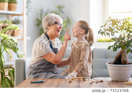 Family caring for plants. 73523768