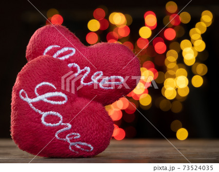 Heart shape on white wood table with colourful bokeh backgrounds 73524035