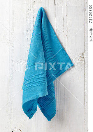 Clean and soft towel hanging at bathroom wall 73526330
