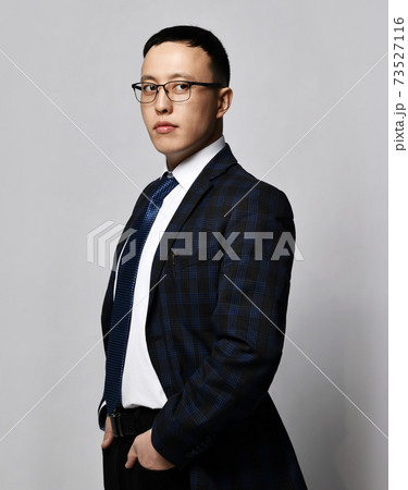 Young businessman in checkered official suit, tie 73527116