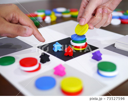 people playing fun board game on wooden table top selected focus people playing fun board game on wooden table top selected focus 73527596