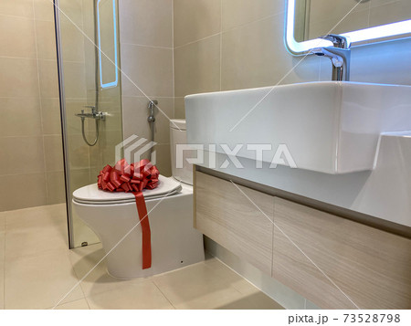 Brand new toilet and sink inside modern restroom 73528798