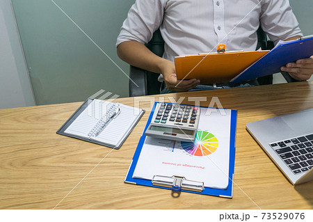 Businessman hands holding report at workplace Businessman hands holding report at workplace 73529076