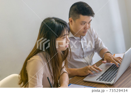 Young business employee work in team on laptop at workplace 73529434