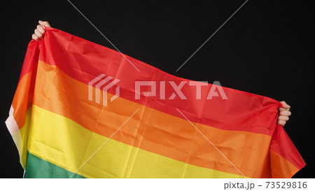 LGBTQ flag or Lesbian Gay Bi sexsual Transgender Queer or homosexsual pride Rainbow flag on black background. Represent hand symbol of freedom, peace, equality and love. LGBTQ concept 73529816