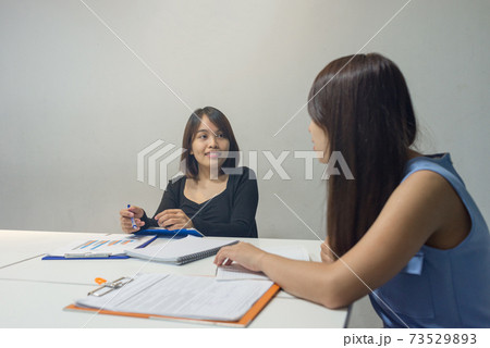 Asian employee discuss with teammate about work Asian employee discuss with teammate about work 73529893