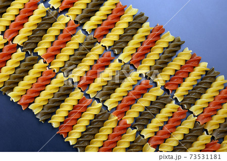 colored dry uncooked vermicelli pasta on dark background colored dry uncooked vermicelli pasta on dark background 73531181
