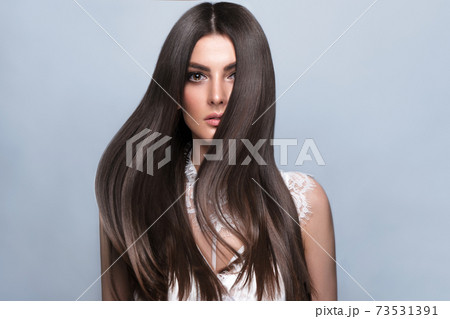 Beautiful brown-haired girl with a perfectly smooth hair, and classic make-up. Beauty face and hair. Beautiful brown-haired girl with a perfectly smooth hair, and classic make-up. Beauty face and hair. 73531391