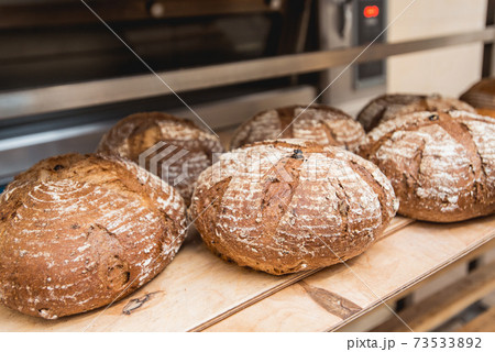 fresh loaves of bread on the shelves in the bakery fresh loaves of bread on the shelves in the bakery 73533892
