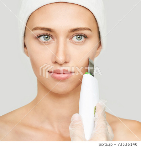 Ultrasonic skin equipment. Woman face cosmetology treatment. Female clinic Ultrasonic skin equipment. Woman face cosmetology treatment. Female clinic 73536140