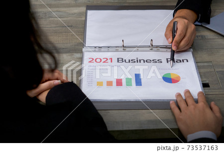 Business meeting on the desk at work. Human hands on a table with document, graph and chart. Business meeting on the desk at work. Human hands on a table with document, graph and chart. 73537163