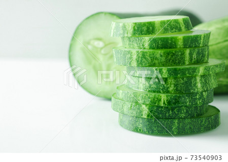 Fresh cucumber slices on white background. Fresh cucumber slices on white background. 73540903