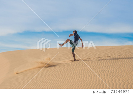 Man kicks the sand, annoyance, aggression Man kicks the sand, annoyance, aggression 73544974