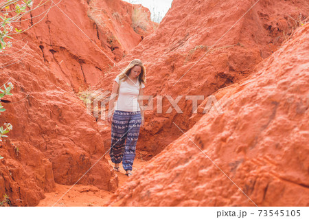 Young woman in red canyon near Mui Ne, southern Vietnam Young woman in red canyon near Mui Ne, southern Vietnam 73545105
