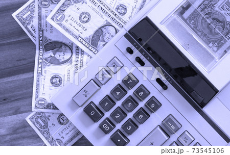 Old fashioned calculator and dollars Old fashioned calculator and dollars 73545106