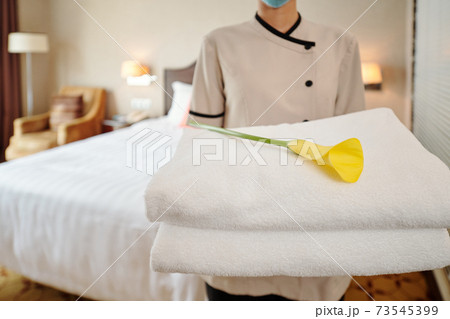 Maid holding fresh towels 73545399