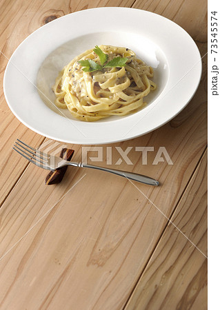 三つ葉が乗っている熱々トリュフクリームの平打ちパスタとフォーク 三つ葉が乗っている熱々トリュフクリームの平打ちパスタとフォーク 73545574