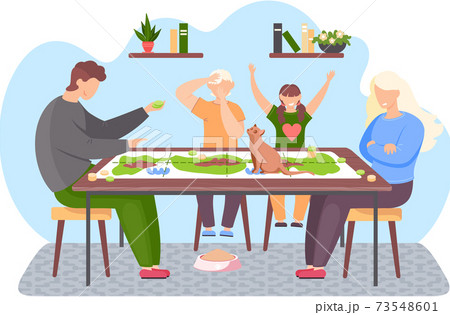 People at home. Happy family is playing board game together. The cat is sitting on the table People at home. Happy family is playing board game together. The cat is sitting on the table 73548601