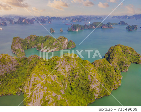 Aerial view panorama of floating fishing village and rock island, Halong Bay, Vietnam, Southeast Asia. UNESCO World Heritage Site. Junk boat cruise to Ha Long Bay. Popular landmark of Vietnam 73549009