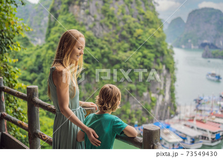 Mom and son travelers in Halong Bay. Vietnam. Travel to Asia, happiness emotion, summer holiday concept. Picturesque sea landscape. Ha Long Bay, Vietnam. After coronavirus COVID 19 Mom and son travelers in Halong Bay. Vietnam. Travel to Asia, happiness emotion, summer holiday concept. Picturesque sea landscape. Ha Long Bay, Vietnam. After coronavirus COVID 19 73549430