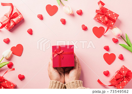 Woman hands holding gift or present box decorated and red heart surprise 73549562