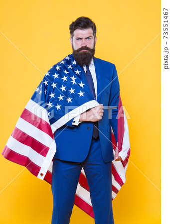 The flag is his pride. Bearded man holding american flag The flag is his pride. Bearded man holding american flag 73551467