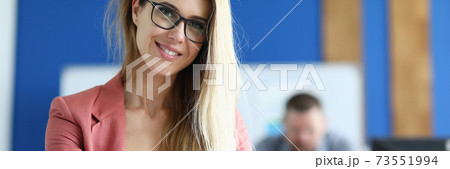 Student hold pen in one hand and folder in other hand in classroom and go through training. 73551994