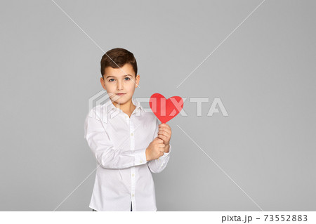 valentine's day. cute little child boy holding red heart 73552883