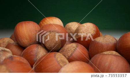 extremely close-up, detailed. many hazelnuts on a dark background extremely close-up, detailed. many hazelnuts on a dark background 73553357