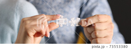 Man and woman connect white puzzles closeup Man and woman connect white puzzles closeup 73553380