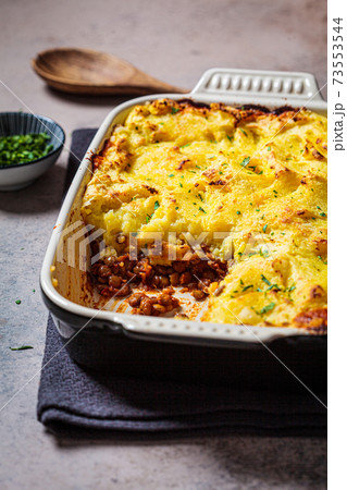 Vegan shepherd's pie with lentils and mashed potatoes in black backing dish. Vegan healthy food concept. 73553544