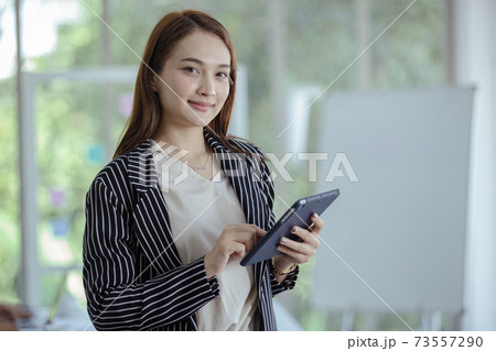 Portrait smile holding tablet looking at camera. Portrait smile holding tablet looking at camera. 73557290