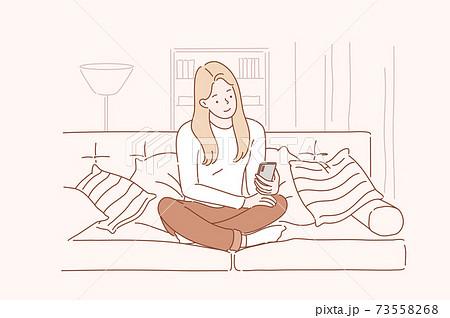 Young smiling attractive woman or girl using a smartphone writes or speaks at home. Concept of communication, comfort, smart. 73558268