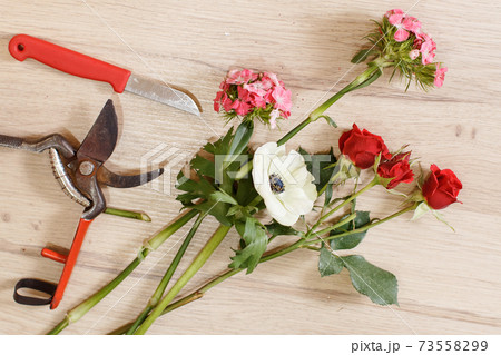 Cutting a flowers at flower shop, top view 73558299