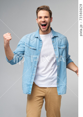 Portrait of young handsome caucasian man in jeans shirt over light background Portrait of young handsome caucasian man in jeans shirt over light background 73560829