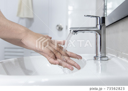 Men are washing their hands in the sinks to clear respiratory bacteria and viruses, sanitation and reduce the spread of COVID-19 that is spread around the world, Hygiene ,Sanitation concept. Men are washing their hands in the sinks to clear respiratory bacteria and viruses, sanitation and reduce the spread of COVID-19 that is spread around the world, Hygiene ,Sanitation concept. 73562823