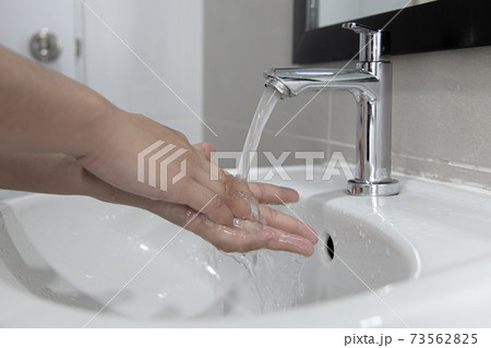 Men are washing their hands in the sinks to clear respiratory bacteria and viruses, sanitation and reduce the spread of COVID-19 that is spread around the world, Hygiene ,Sanitation concept. 73562825