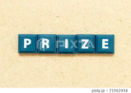 Tile alphabet letter in word prize on wood background Tile alphabet letter in word prize on wood background 73562938
